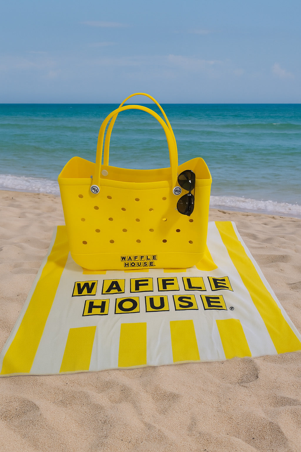 Yellow tote bag on a Waffle House branded towel at the beach