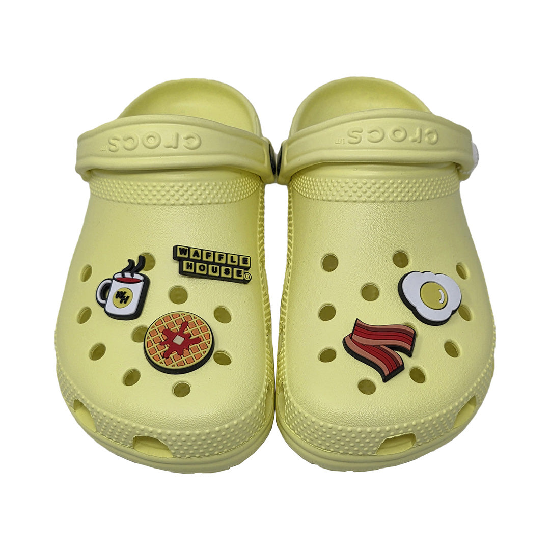 Pair of light yellow clogs with waffle house themed shoe charm