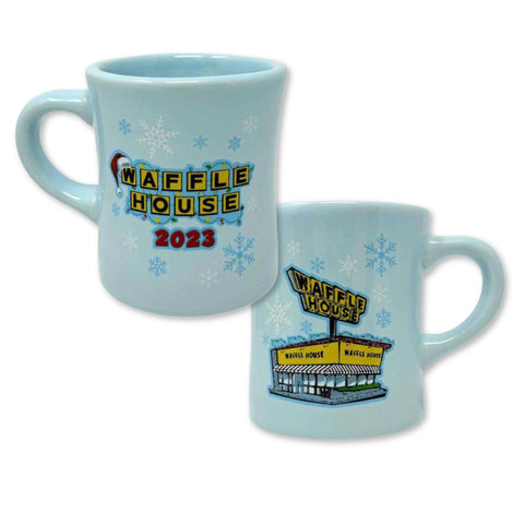 Light Blue mug with a front design of Waffle House logo with Santa hat and 2023, back design of Waffle House building and snowflakes