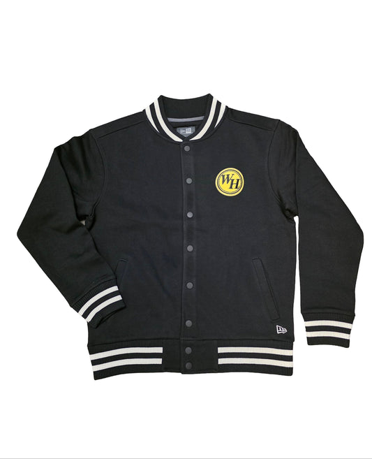 It’s a black varsity-style jacket with striped cuffs and collar, featuring a small yellow “WH” patch on the left chest.
