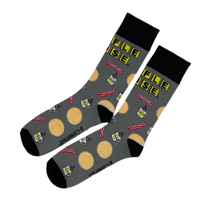 pair of black and grey dress socks with Waffle House logo, bacon, waffles and coffee cup printed on them