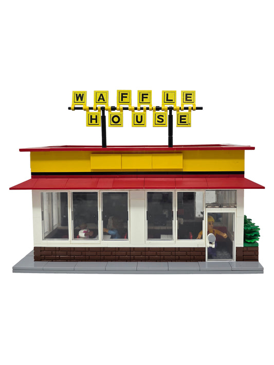 Model of a Waffle House restaurant with a red roof and yellow facade.