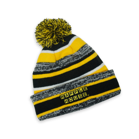 black, yellow and grey striped beanie with pom on top and Waffle House logo on cuff