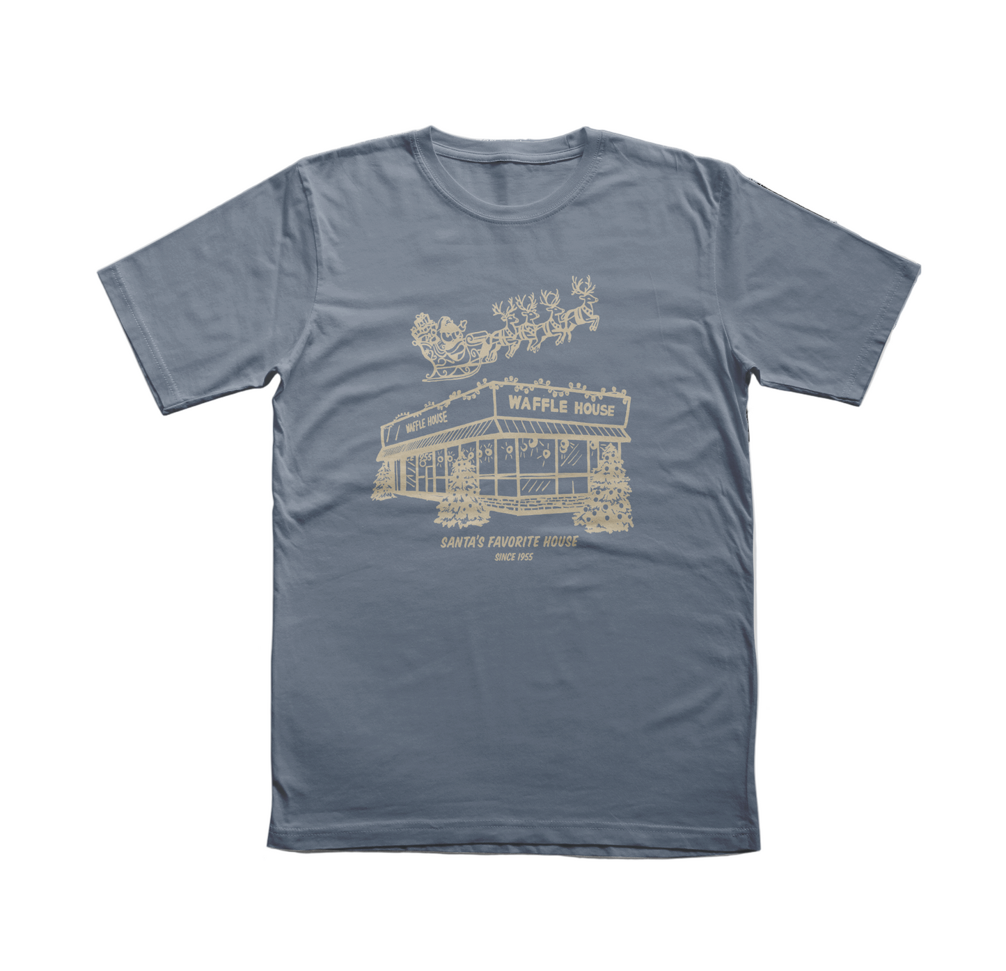 Blue t-shirt featuring a cream-colored drawing of Santa and his reindeer flying over a snowy Waffle House with the words “Santa’s Favorite House Since 1955.