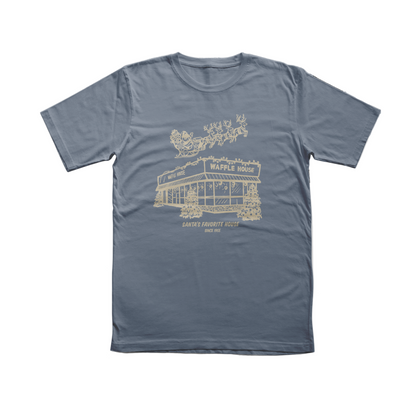 Blue t-shirt featuring a cream-colored drawing of Santa and his reindeer flying over a snowy Waffle House with the words “Santa’s Favorite House Since 1955.