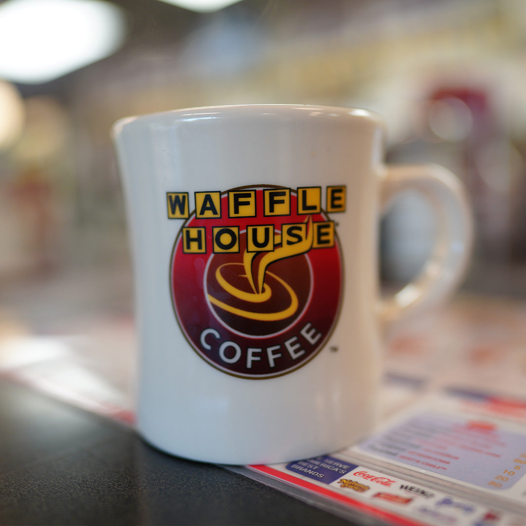 Waffle House coffee mug sitting on counter inside a Waffle House