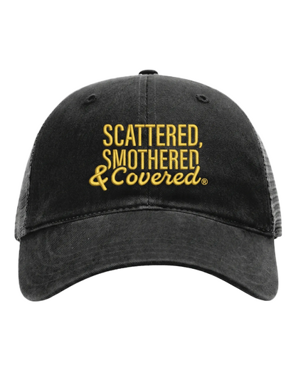 A black baseball cap with gold embroidered text reading “Scattered, Smothered & Covered."