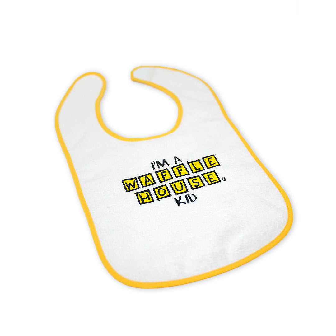 White baby bib with yellow trim with I'm a Waffle House kid on the front