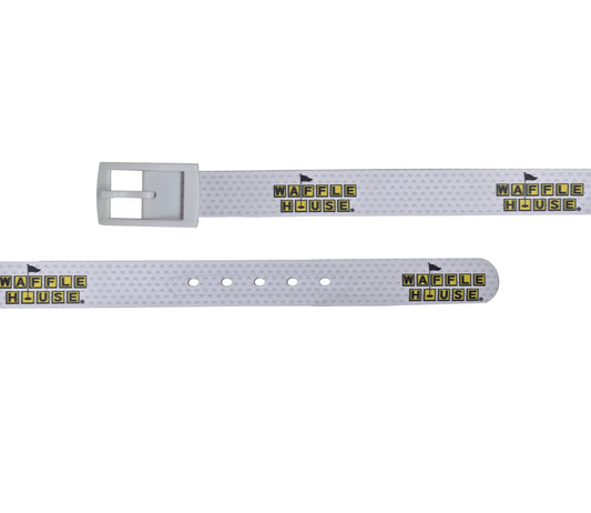 White golf belt laid flat in two straight lengths, showing the buckle end and the hole end. The strap has a golf-ball dimple texture and a repeating yellow and black Waffle House logo, with a golf flag rising from the “O” in HOUSE.