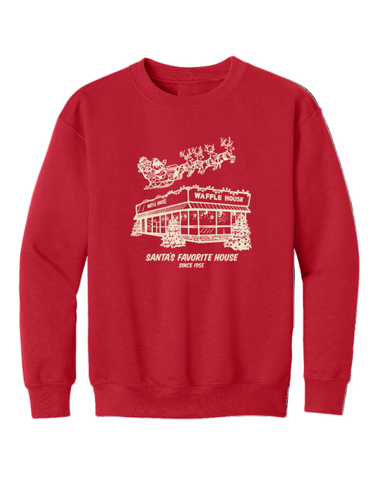 Youth red sweatshirt featuring a cream-colored drawing of a snowy Waffle House with Santa and his reindeer flying overhead, along with the words “Santa’s Favorite House Since 1955.