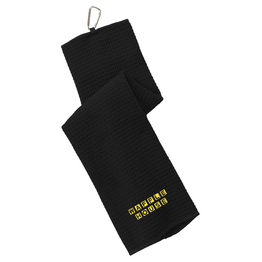 Black tri-fold waffle-textured golf towel with an embroidered Waffle House logo in yellow on the lower panel. A silver metal carabiner clip is attached at the top corner.