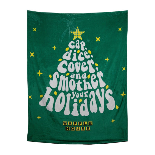 Green fleece blanket laid flat with white and yellow holiday tree of cap, dice, cover, and smother your holidays in words and the Waffle House logo