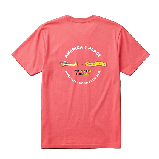 Back of coral Waffle House t-shirt with arched "America's Place" text above a yellow banner plane pulling a "Scattered, Smothered & Covered" flag, Waffle House logo below, "Since 1955 – Good Food Fast" along bottom arc