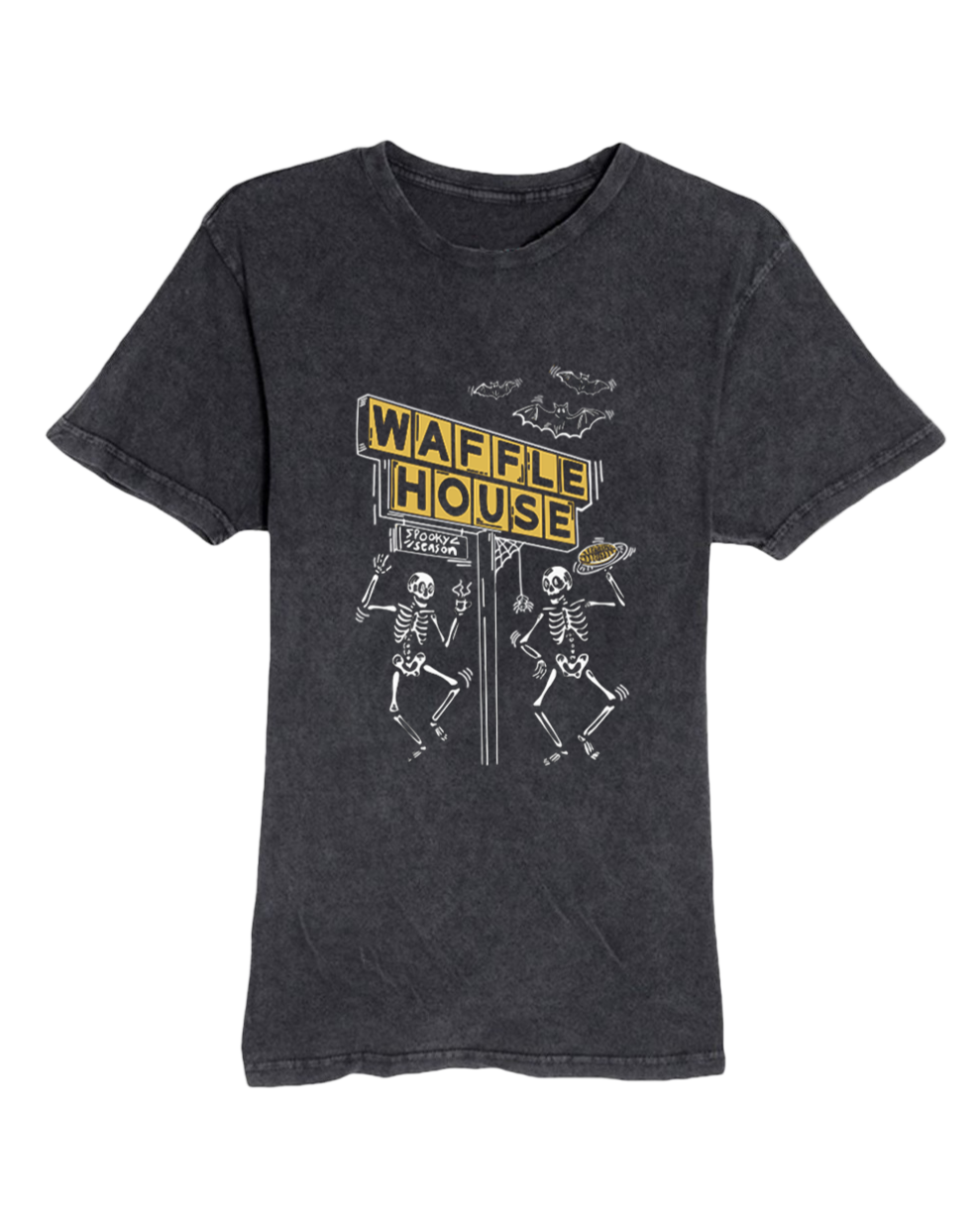Black mineral-wash T-shirt with a Halloween-themed Waffle House design. The graphic shows the yellow Waffle House sign above two dancing skeletons, one holding a waffle, with bats flying overhead and the words ‘Spooky Season’ written on the sign.