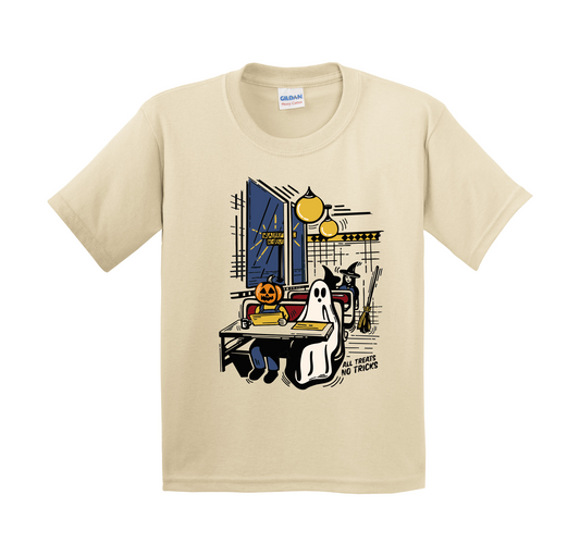 A beige youth t-shirt with a cartoon Halloween waffle house scene. A pumpkin-headed character and a ghost sit together in a booth, reading menus. A witch stands nearby with her broom. The words ‘All Treats No Tricks’ are printed at the bottom.