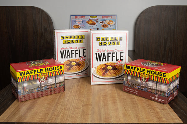Two boxes of Waffle House waffle mix and two boxes of Waffle House Coffee single cup coffee pods on table